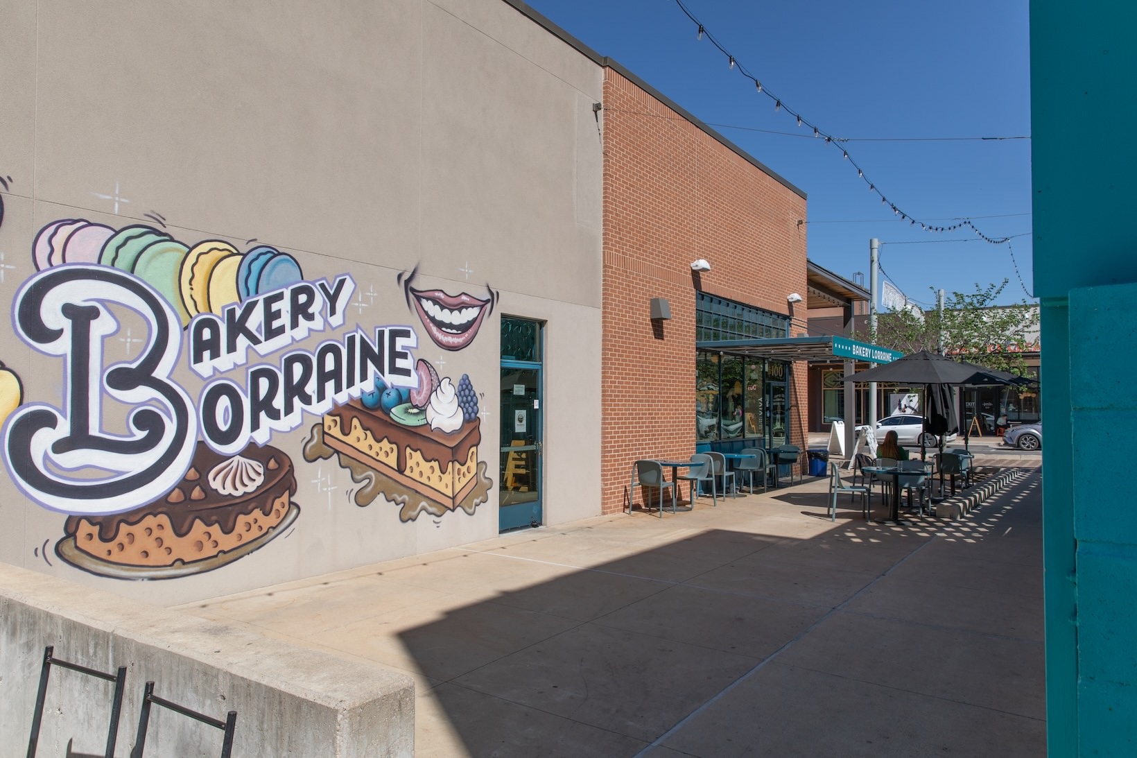 Bakery Lorraine outdoor patio with painting on a building