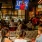 a patio at a restaurant with tvs and booths full of people eating