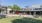 a large lawn in front of a group of restaurants