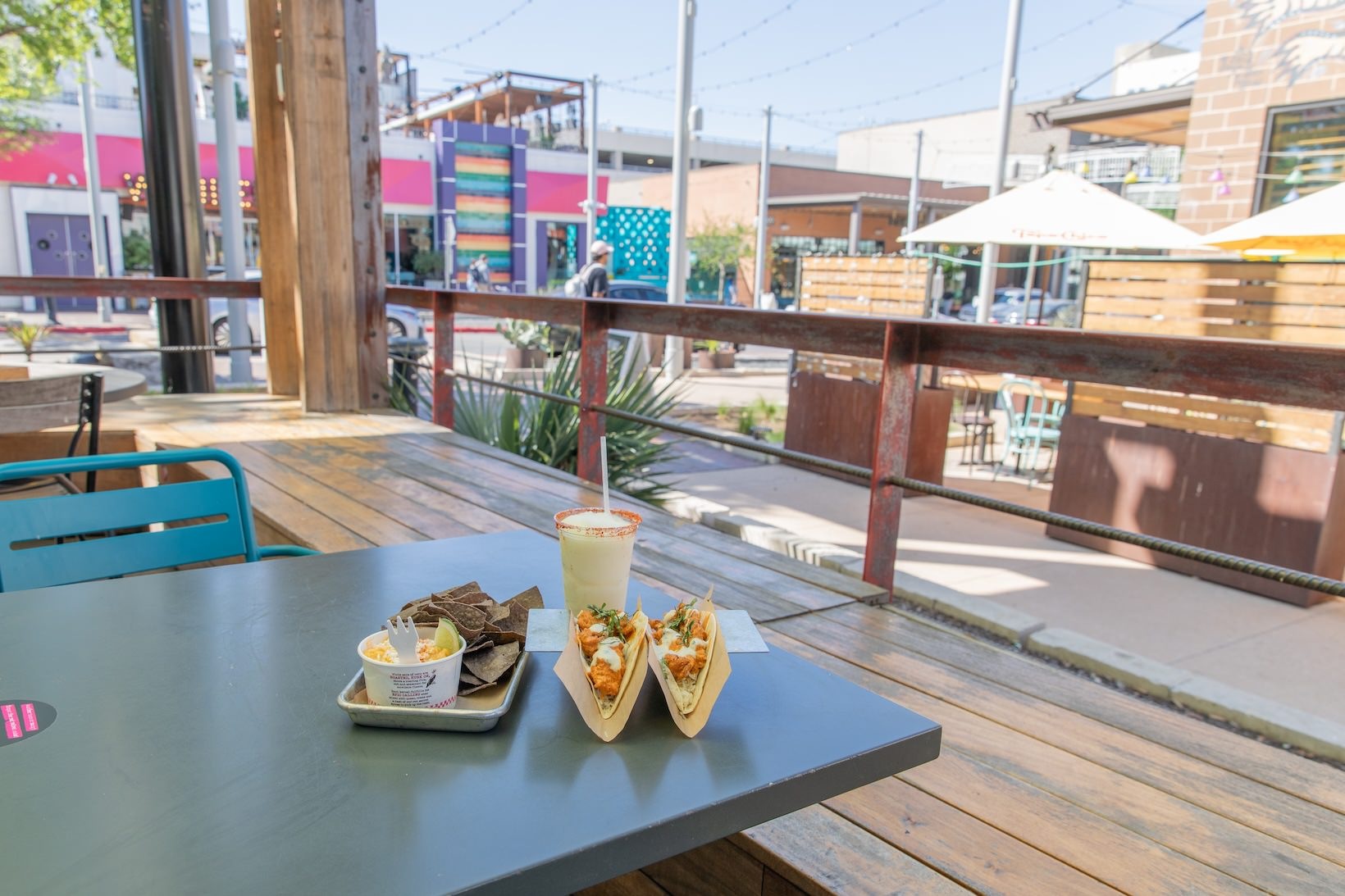 Velvet Taco a table with tacos, chips and queso, and a drink