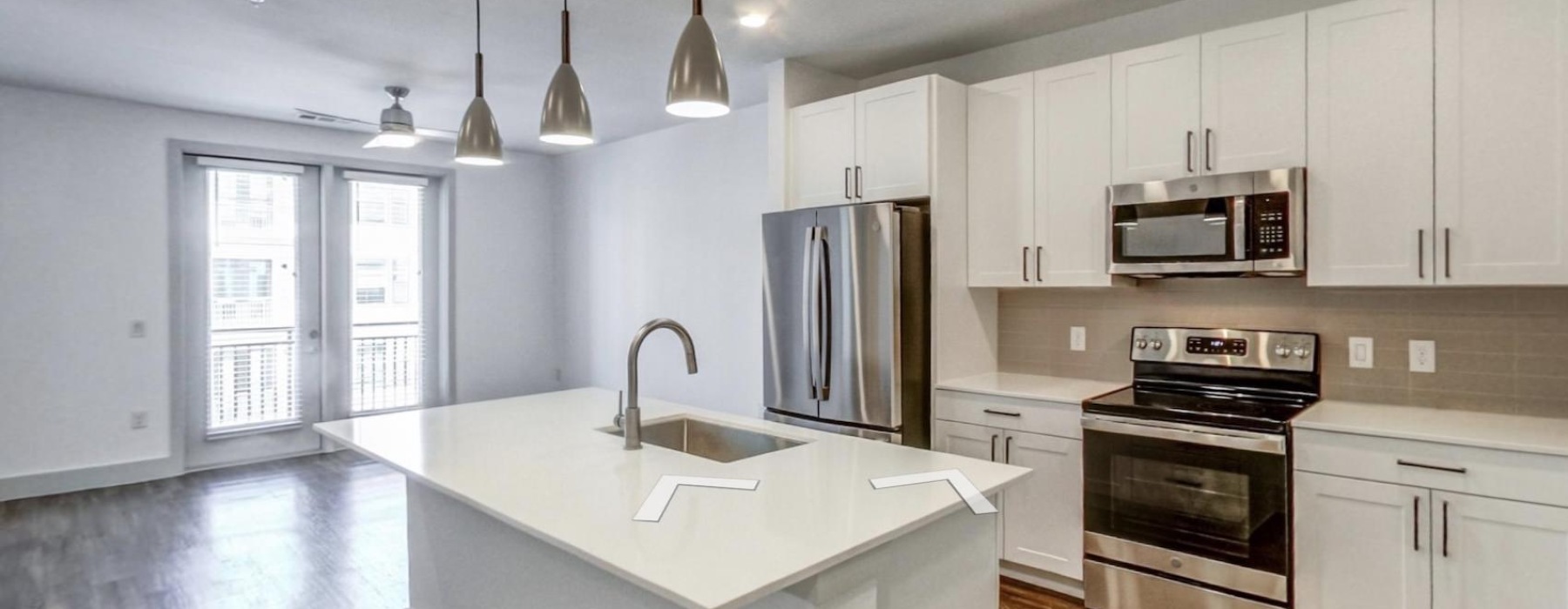 Modern kitchen with a large island and stainless steel appliances at The Met