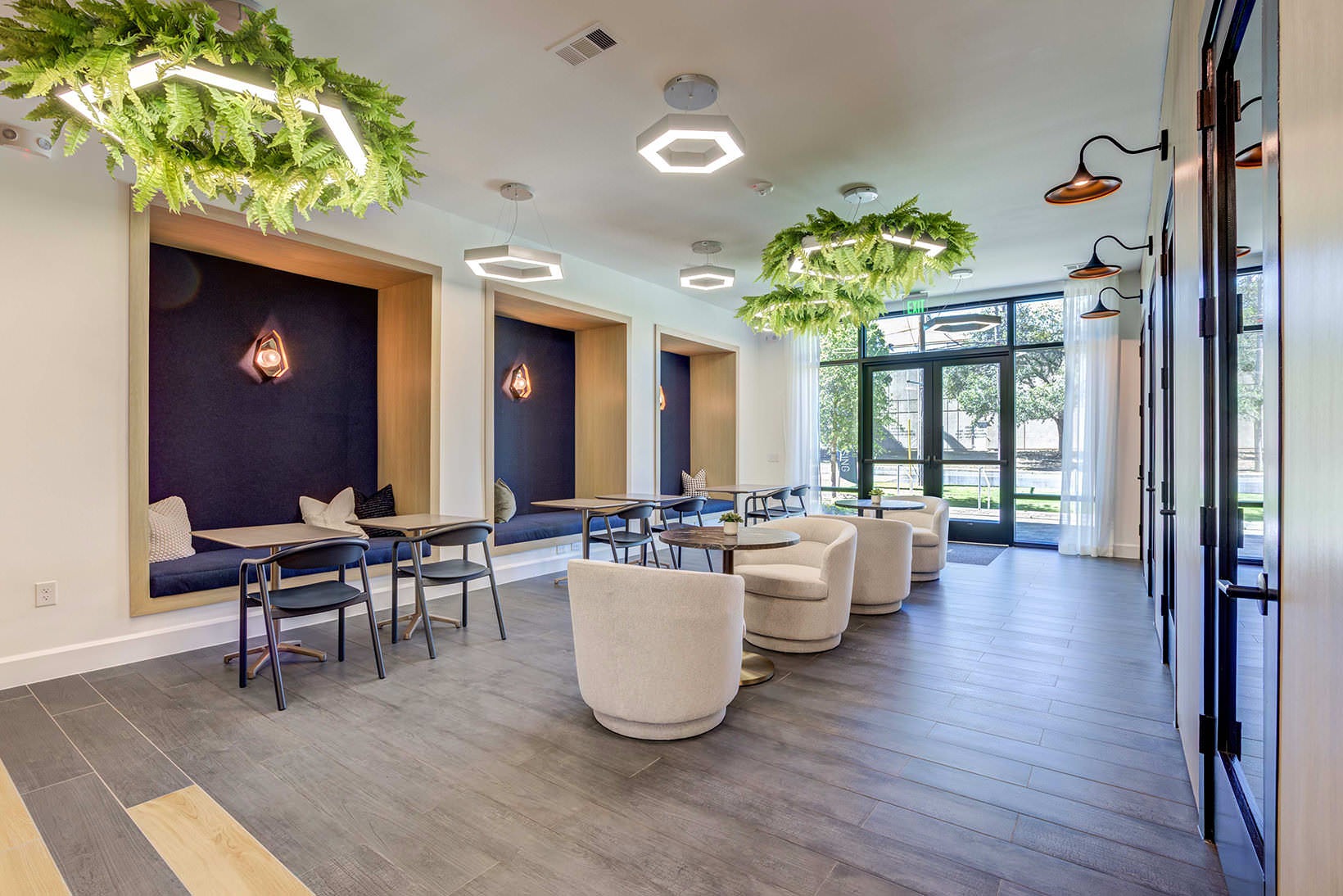 Clubhouse clubhouse lobby with tables, chairs and booths